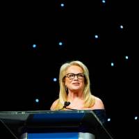 Pamella DeVos at the podium at Enrichment